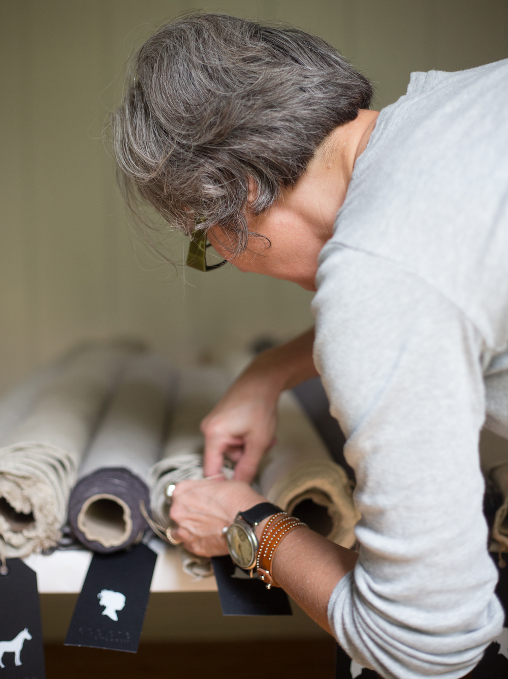 Darva adding a Sturdy Girl Tag to roll of fabric